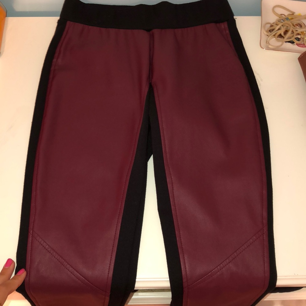 Maroon and black leather leggings